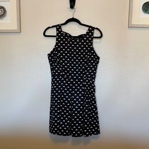 Black geometric mini dress with back bow detail and side zip closure